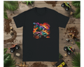 Black t-shirt with a colorful dinosaur and monster truck graphic on a wooden background with toy vehicles and plants.