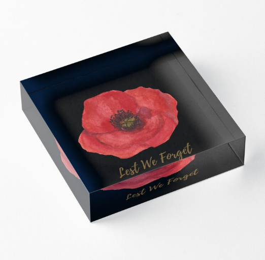  flat lay image of acrylic block decor with red poppy print and text Lest We Forget