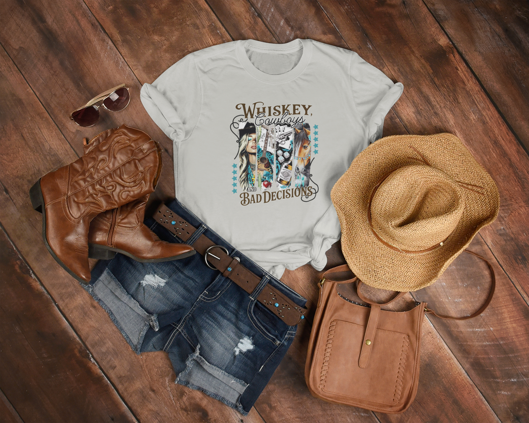 White t-shirt with graphic design, cowboy boots, hat, and purse on a wooden surface