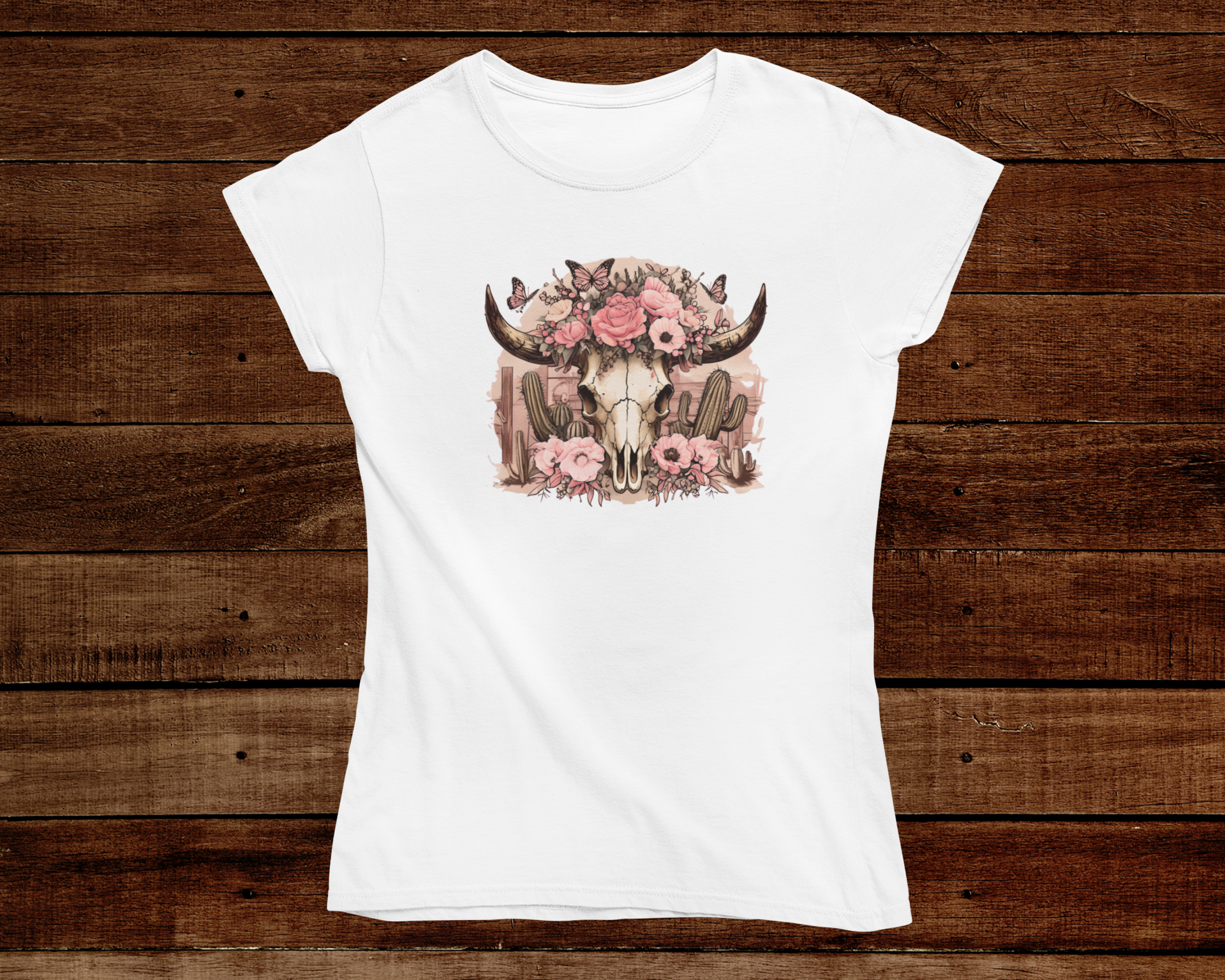 White t-shirt with a bull skull and floral design on a wooden background