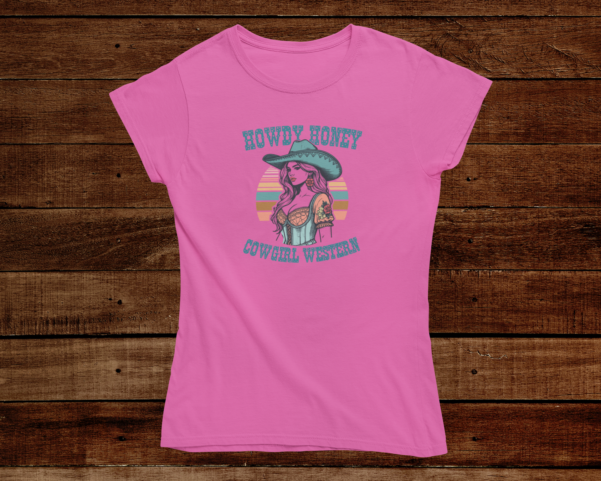 Pink t-shirt with a graphic design of a cowgirl on a wooden background
