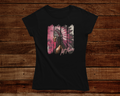 Black t-shirt with a colorful graphic design on a wooden background