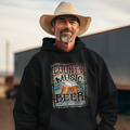 Man wearing a hoodie with 'County Music and Beer That's Why I'm Here' text, standing outdoors.